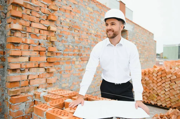 A construction worker controlling the construction of roof structures on construction site.