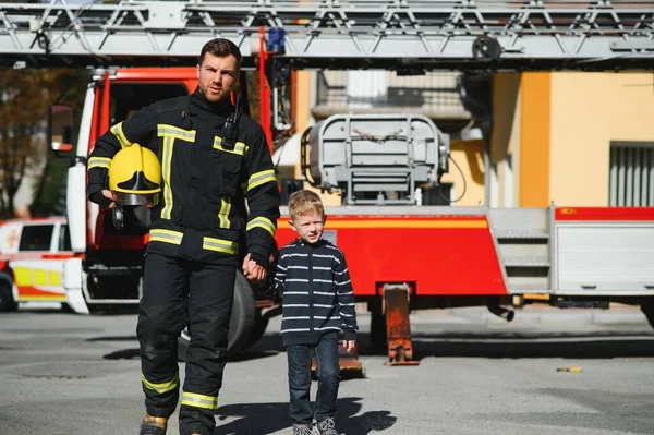 Firefighter holding child boy to save him in fire and smoke,Firemen rescue the boys from fire.