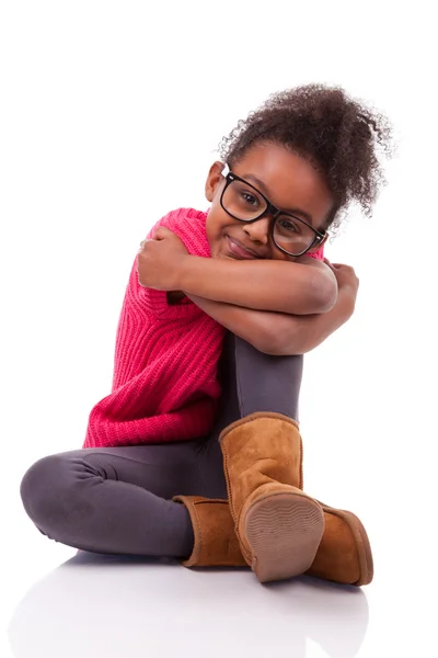 Cute young African American girl seated on the floor — Stock Photo, Image