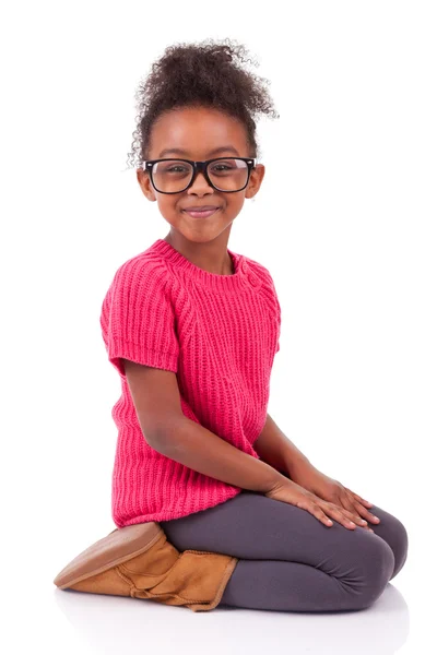 Cute young African American girl seated on the floor — Stock Photo, Image