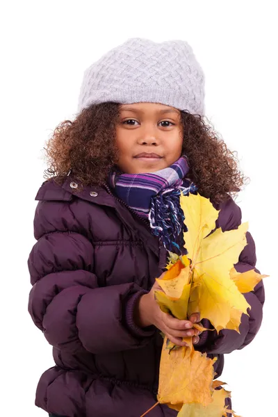 Little african asian girl wearing winter clothes playing with le — Stock Photo, Image