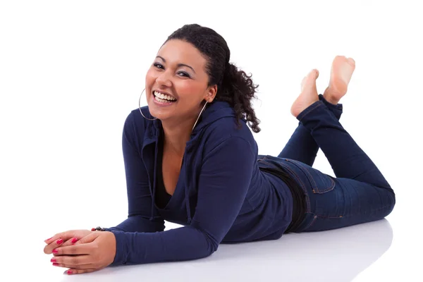 Young African American woman lying down on the floor — Stock Photo, Image