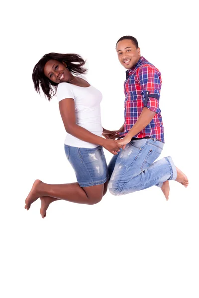 Happy young African American couple jumping — Stock Photo, Image