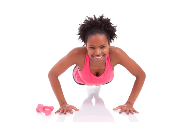 Young beautiful african fitness woman doing push up exercises on — Stock Photo, Image