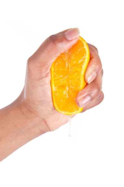 African American hand squeezing an orange slice — Stock Photo, Image