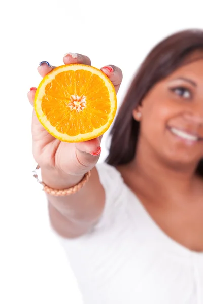 Young happy indian woman holding an orange slice — Zdjęcie stockowe