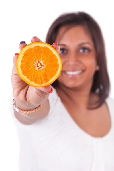 Young happy indian woman holding an orange slice — Zdjęcie stockowe