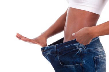 Young african woman in old jeans pant after losing weight clipart