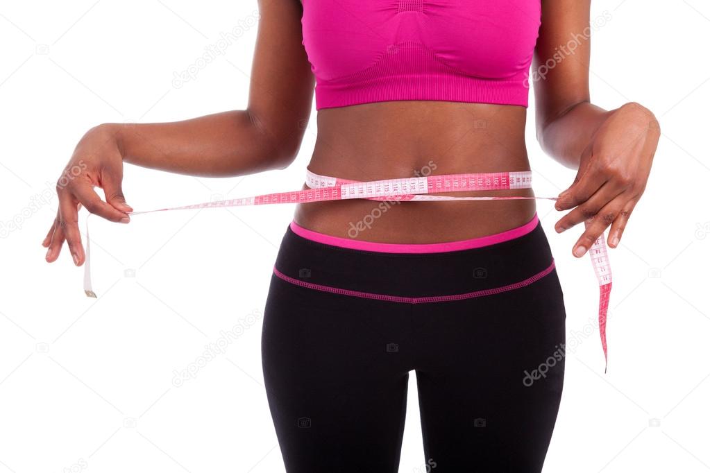 African American Fitness woman measuring her belly