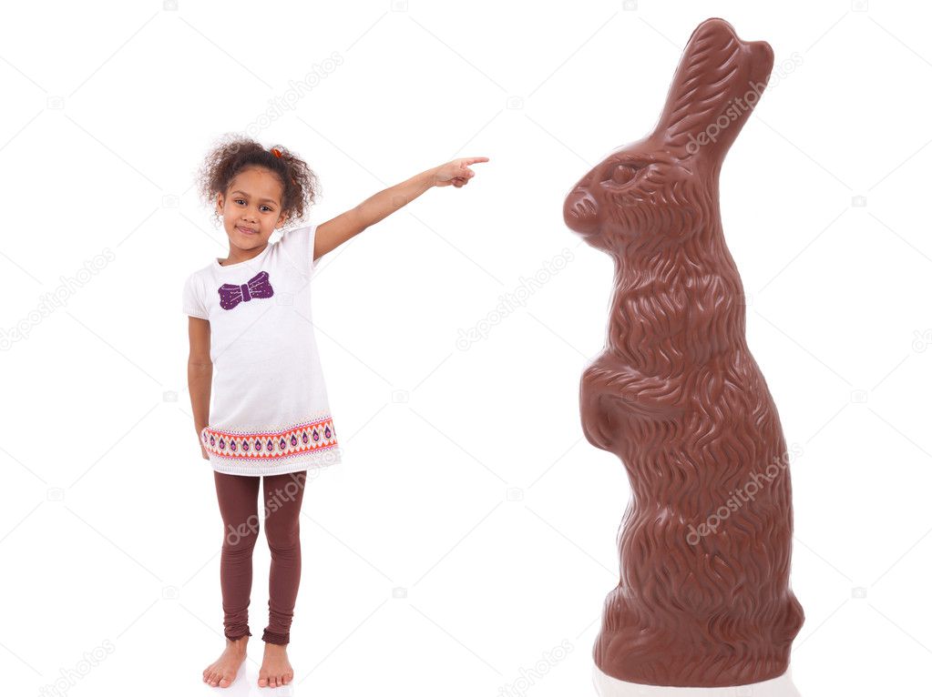 African Asian girl pointing a giant chocolate rabbit