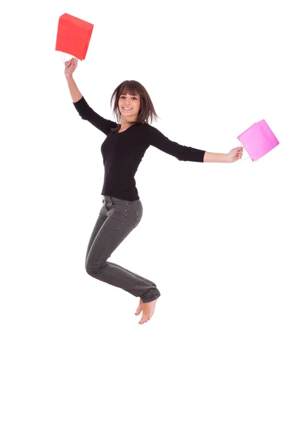 Mulher caucasiana feliz pulando com sacos de compras — Fotografia de Stock