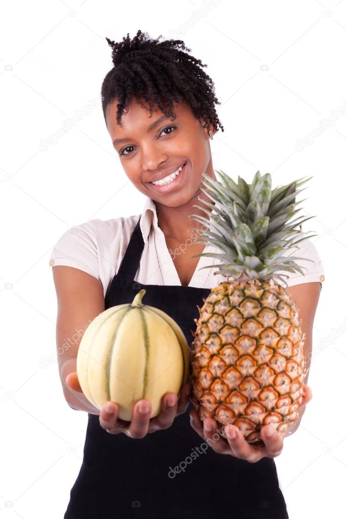 Young happy black african american woman selling fresh fruits