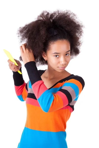 Black African American teenage girl combing her afro hair — Stock Photo, Image