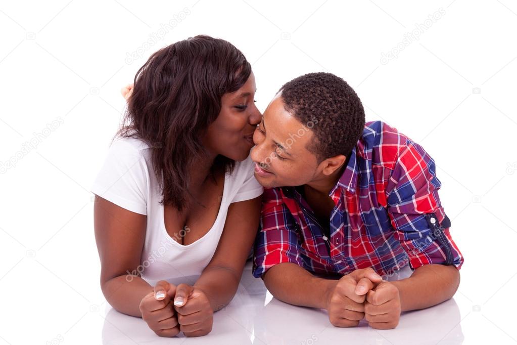 Happy young black African American couple lying down on the floo