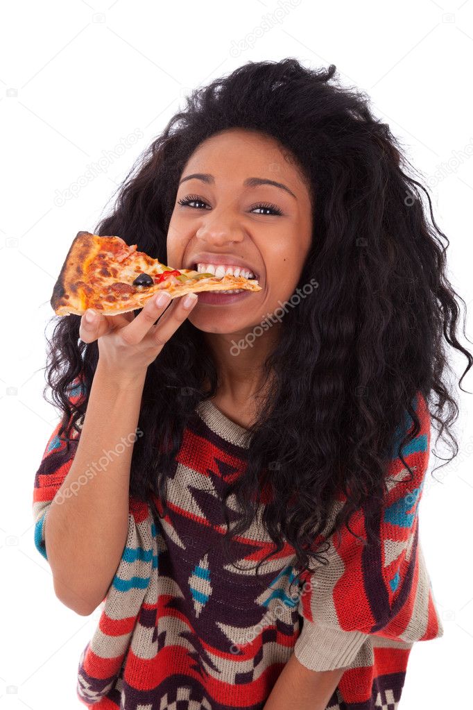 Young black african american teenage girl eating a slice of pizz