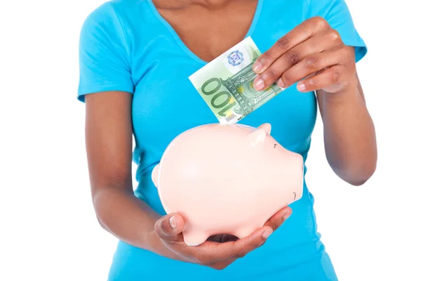 Black african american woman inserting a euro bill inside a smil — Stock Photo, Image