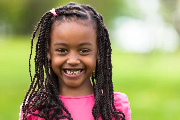 Outdoor close up portrait of a cute young black girl - African p Royalty Free Stock Images