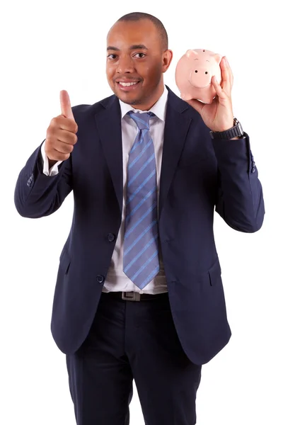 Hombre de negocios afroamericano sosteniendo una alcancía haciendo pulgares —  Fotos de Stock