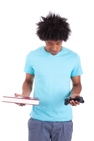 Young black teenage men holding a book and a video game controll — Stock Photo, Image