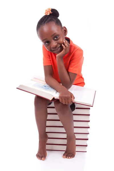 Cute black african american little girl reading a book - African Stock Image