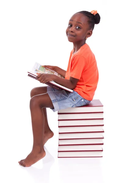 Cute black african american little girl reading a book - African Royalty Free Stock Photos