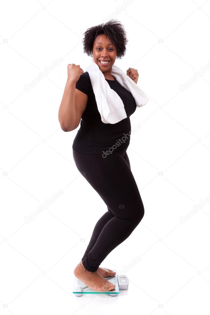 African American woman cheering on scale - African