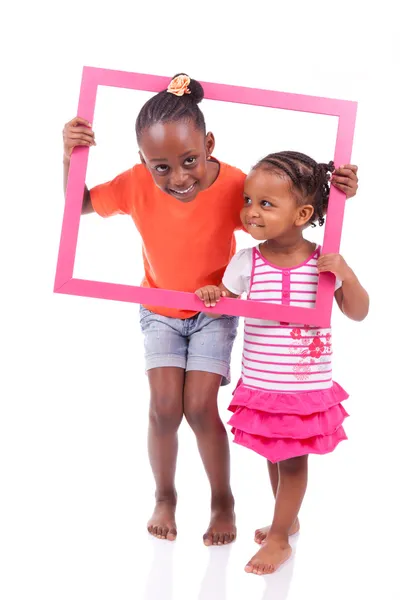 Africké americké holčičky, držící rámeček obrázku — Stock fotografie
