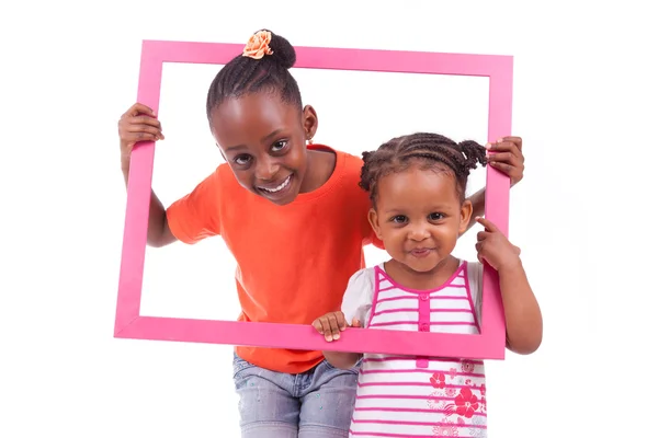 Little african american girls holding a picture frame — Stock Photo, Image