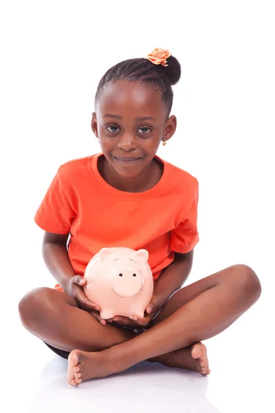 Cute little black girl holding a smiling piggy bank - African ch — Stock Photo, Image