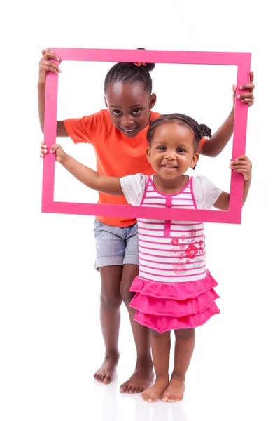 Little african american girls holding a picture frame — Stock Photo, Image