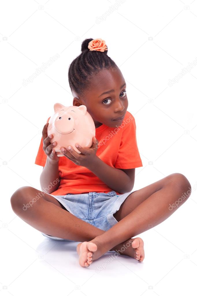 Cute little black girl holding a smiling piggy bank - African ch