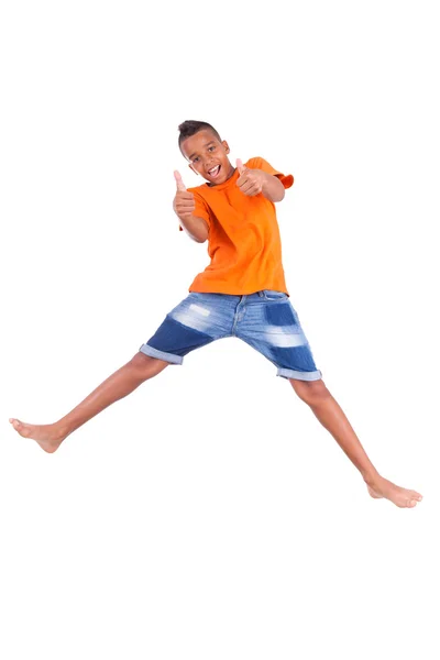 Portrait of a cute teenage black boy jumping over white backgrou — Stock Photo, Image