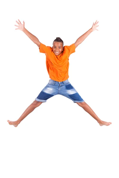 Portrait of a cute teenage black boy jumping over white backgrou — Stock Photo, Image