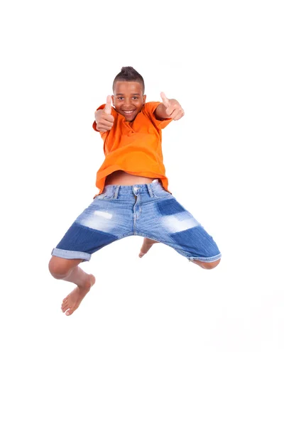 Portrait of a cute teenage black boy jumping over white backgrou — Stock Photo, Image