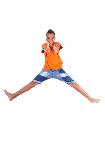 Portrait of a cute teenage black boy jumping over white backgrou — Stock Photo, Image