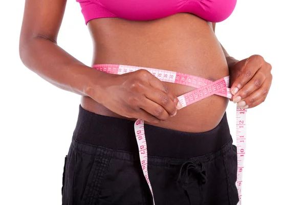 Young pregnant black woman measuring her belly - African people — Stock Photo, Image