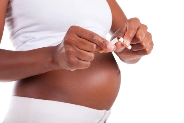 Mujer negra embarazada joven rompiendo un cigarrillo - Personas africanas — Foto de Stock