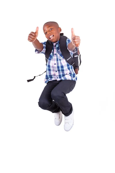 Niño de escuela afroamericano saltando y haciendo pulgares hacia arriba - Negro —  Fotos de Stock