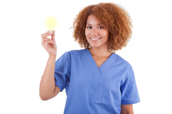 African American nurse holding a light bulb - Black people — Stock Photo, Image