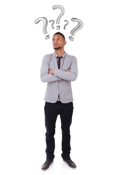 Young thoughtful african american man surrounded by question ma — Stock Photo, Image