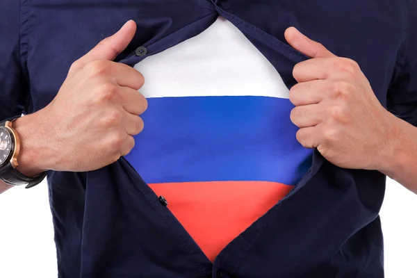 Young sport fan opening his shirt and showing the flag his count — Stock Photo, Image