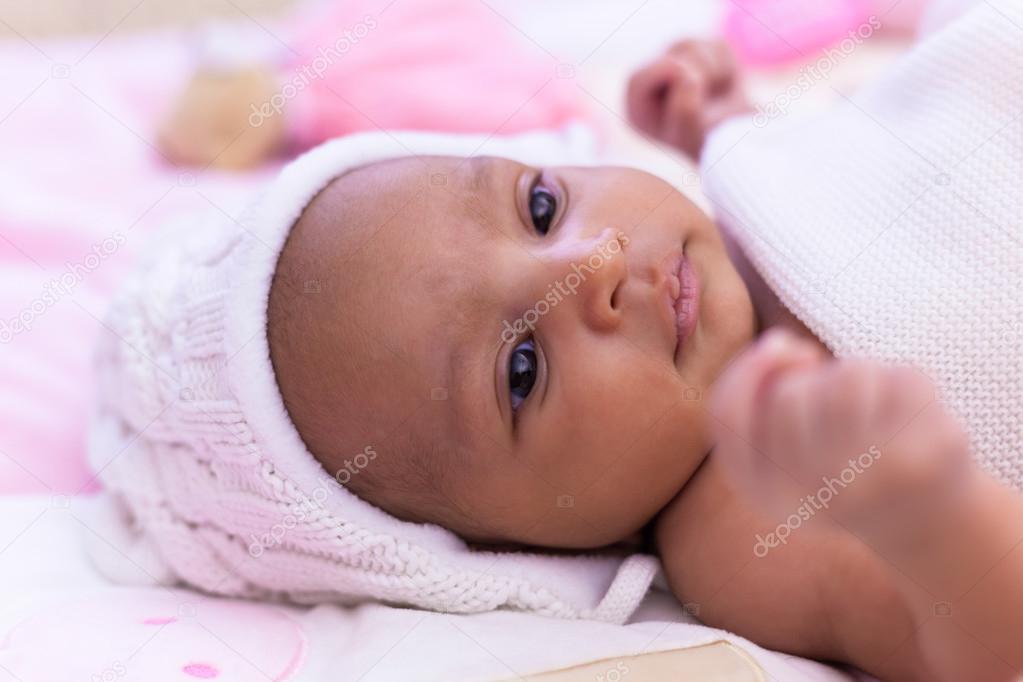 Adorable little african american baby girl looking - Black peopl