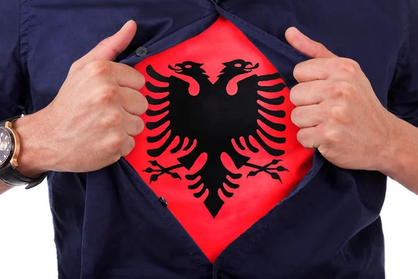 Young sport fan opening his shirt and showing the flag his count — Stock Photo, Image