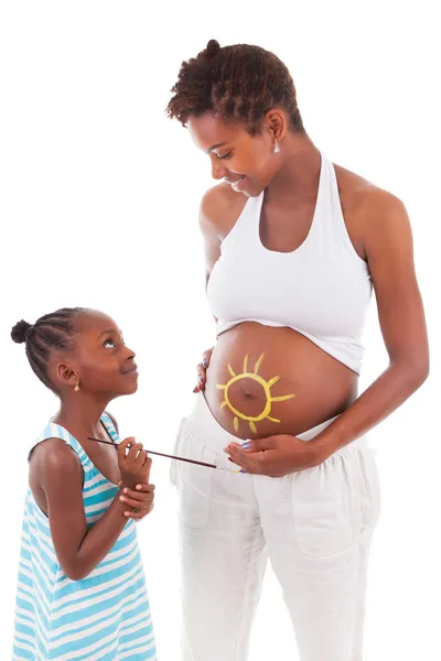 Little african american girl painting on her mother's belly - Af — Stock Photo, Image