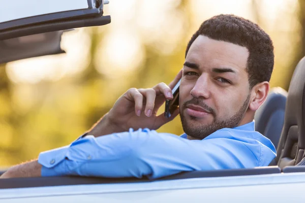 Young latin american driver making a phone call while driving — Stock Photo, Image