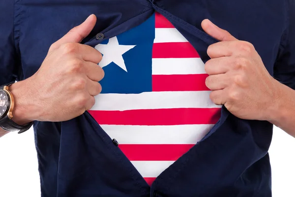 Young sport fan opening his shirt and showing the flag his count — Stock Photo, Image