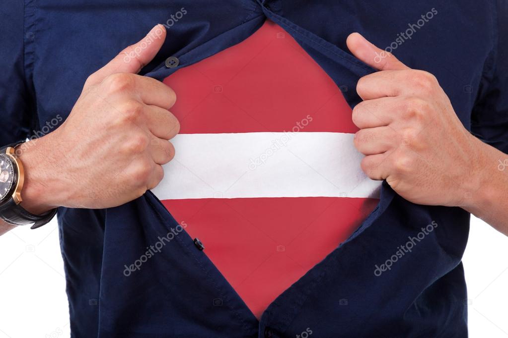 Young sport fan opening his shirt and showing the flag his count