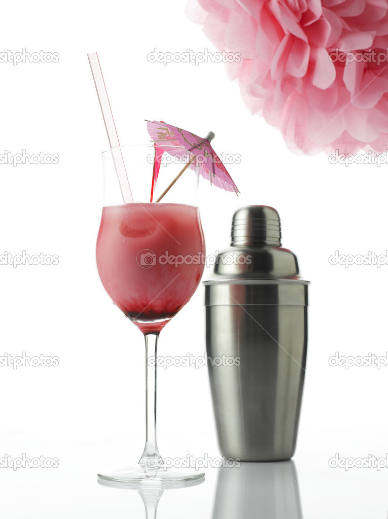 Cocktail with drink umbrella and shaker