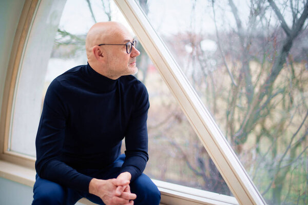 Casual Man Wearing Turtleneck Sweater While Deep Thought Looking Out Stock Picture