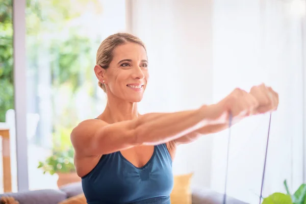 Shot Middle Aged Woman Using Resistance Band While Working Out — Foto de Stock